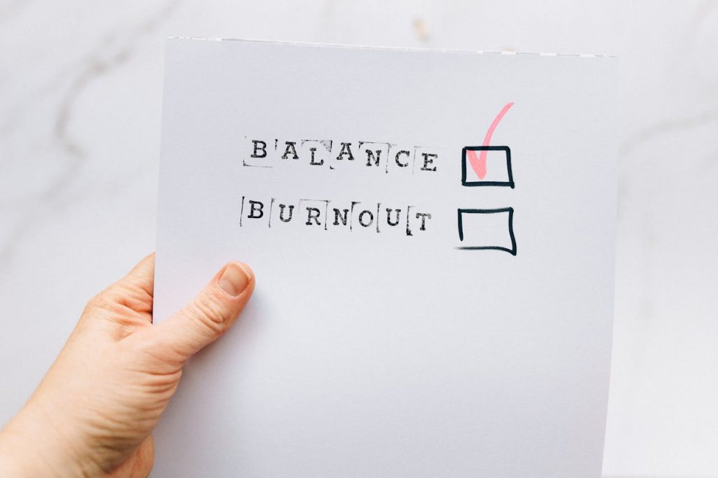 A close up of a To-Do list with the items: balance and burnout written down. Balance has a red check mark in the checkbox.